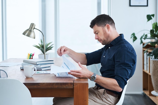 A person organizing documents on a desk, including a driver's license, utility bill, and a printed claim form. The image conveys organization and attention to detail, highlighting the importance of proper documentation for filing a claim.
